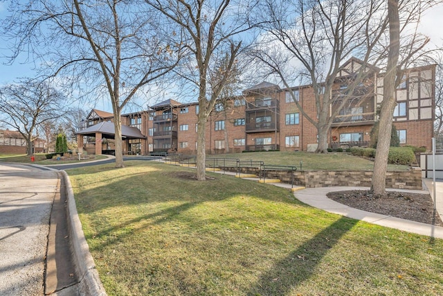 view of property's community with a lawn and a gazebo