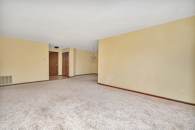 unfurnished room featuring carpet and a textured ceiling