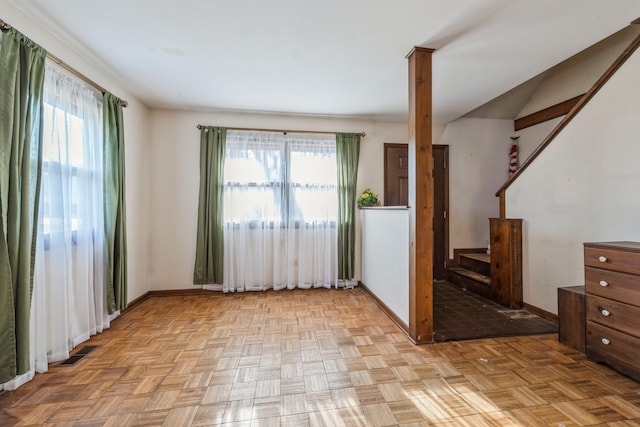 empty room with a wealth of natural light and light parquet floors