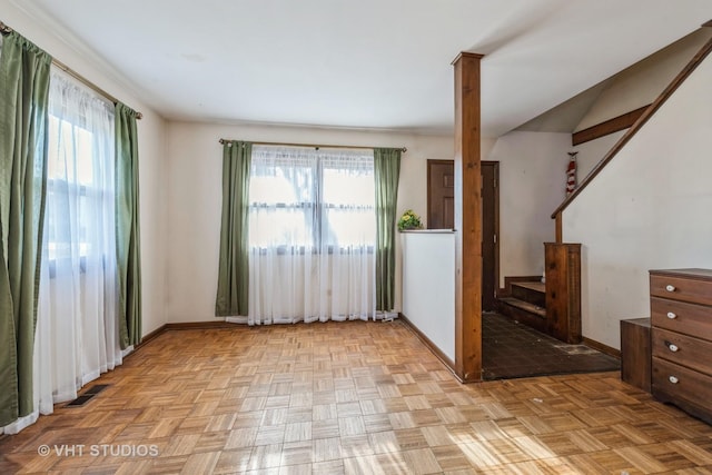 spare room featuring visible vents, baseboards, and a healthy amount of sunlight