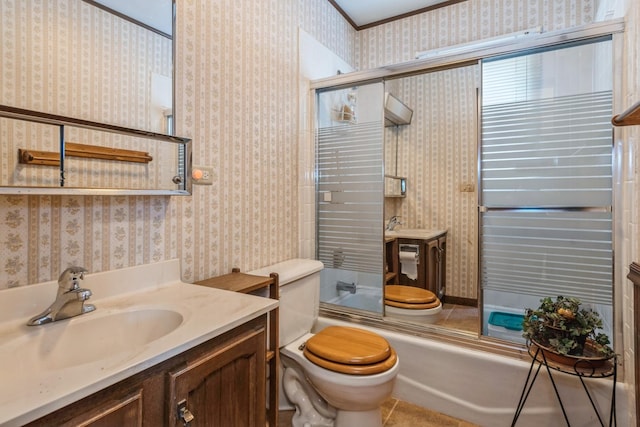 full bathroom featuring toilet, vanity, and combined bath / shower with glass door