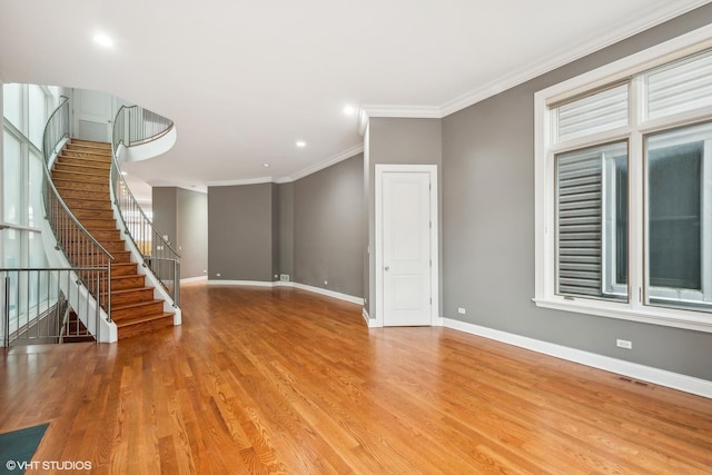 unfurnished living room featuring crown molding and light hardwood / wood-style flooring