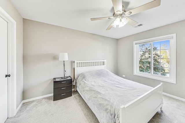 bedroom featuring light colored carpet and ceiling fan