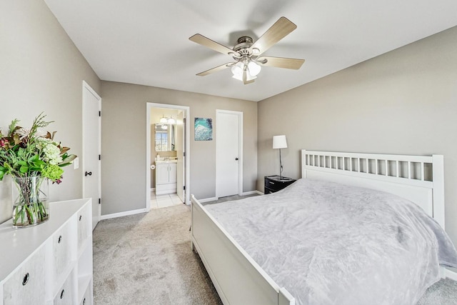 bedroom with ensuite bathroom, ceiling fan, and light colored carpet