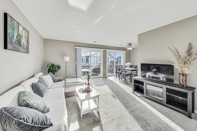 living room featuring carpet flooring and ceiling fan