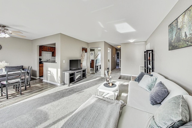 living room with hardwood / wood-style flooring and ceiling fan