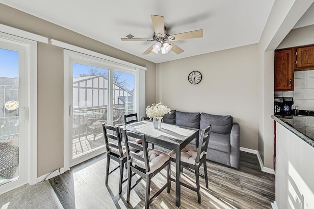 dining room with hardwood / wood-style flooring and ceiling fan