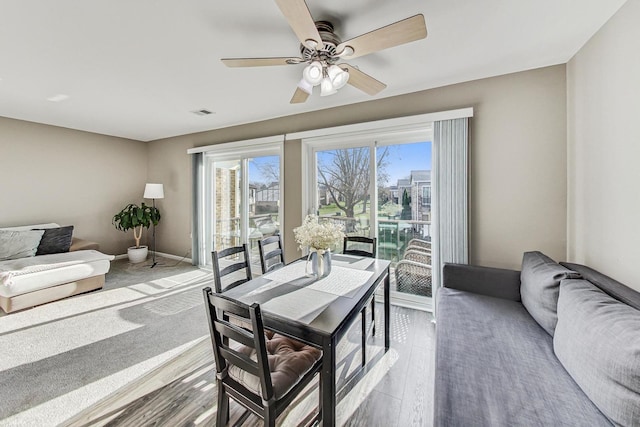 dining area featuring ceiling fan and light hardwood / wood-style flooring