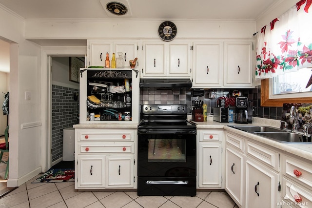 kitchen featuring sink, electric range, ornamental molding, light tile patterned flooring, and white cabinetry