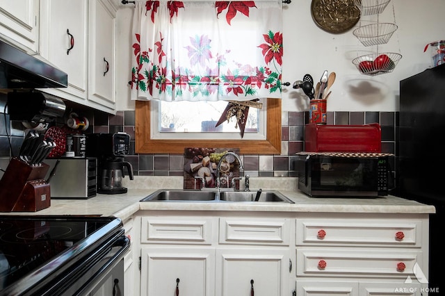 kitchen with tasteful backsplash, white cabinetry, and sink