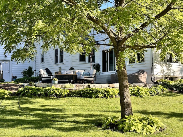 rear view of house featuring a yard