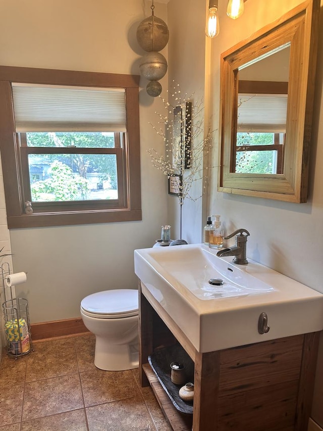 bathroom with tile patterned floors, vanity, and toilet