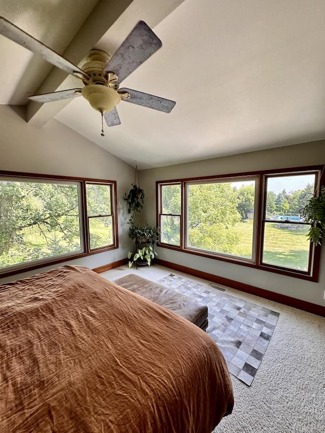 carpeted bedroom with vaulted ceiling with beams and ceiling fan