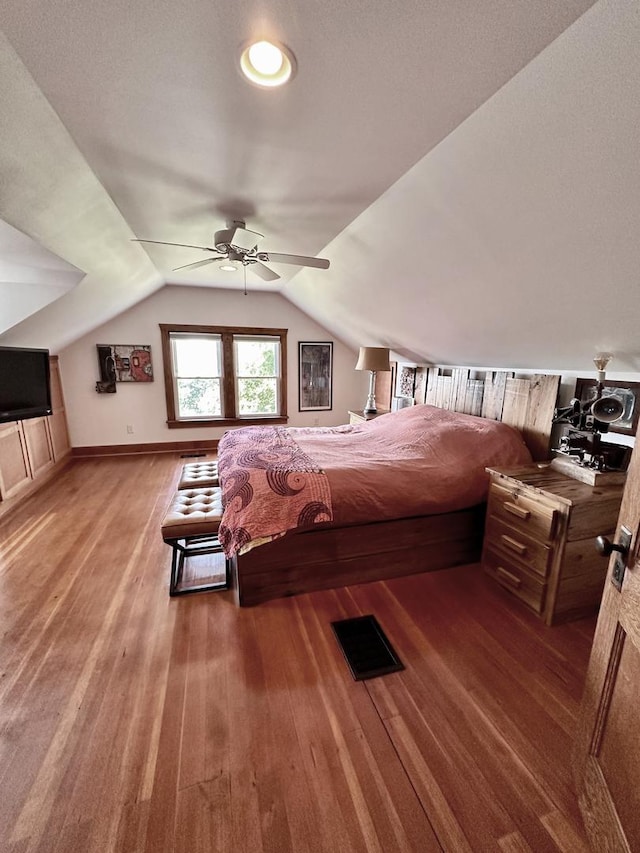 bedroom with hardwood / wood-style floors, ceiling fan, and lofted ceiling