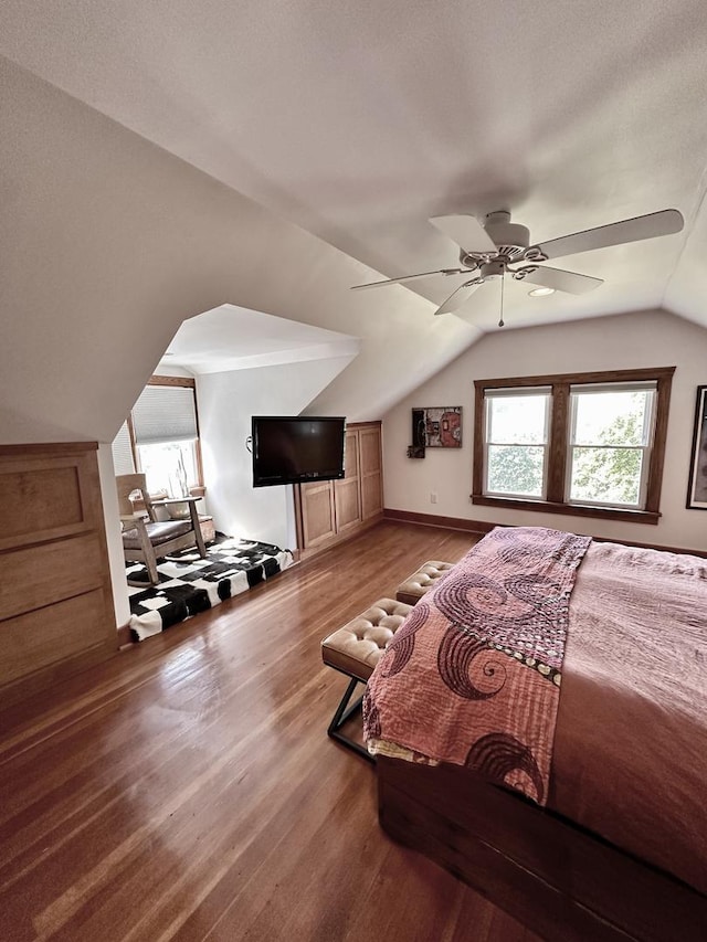 bedroom with hardwood / wood-style floors, vaulted ceiling, and ceiling fan