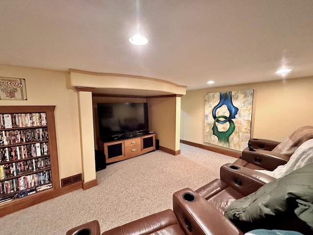 cinema room with light colored carpet