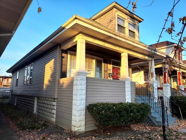 view of side of property featuring a porch