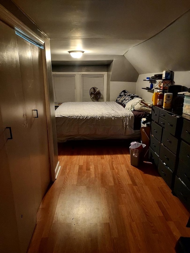 bedroom featuring light hardwood / wood-style flooring and vaulted ceiling