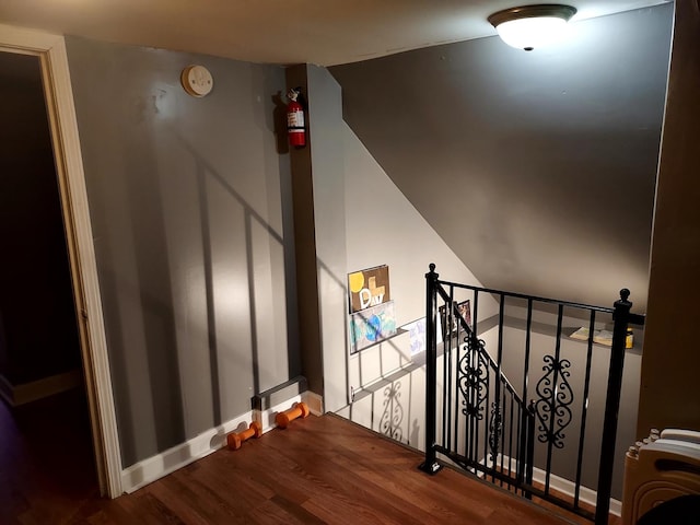 staircase featuring wood-type flooring