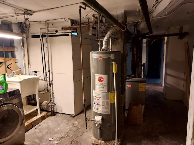 utility room featuring water heater, sink, and washer / dryer