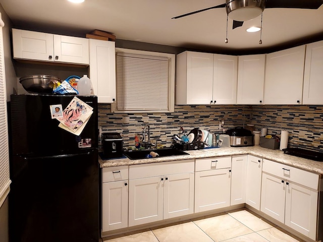 1408 W 71st Pl, Chicago, IL 60636 - kitchen with freestanding refrigerator, decorative backsplash, white cabinetry, light countertops, and light tile patterned floors