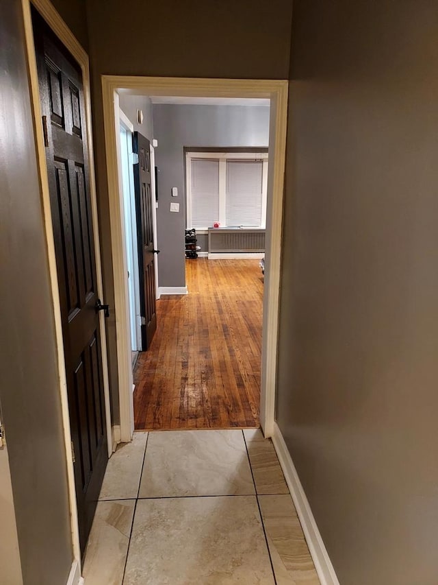 hallway with light hardwood / wood-style floors