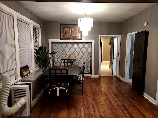 dining room with a chandelier, heating unit, and dark wood-type flooring