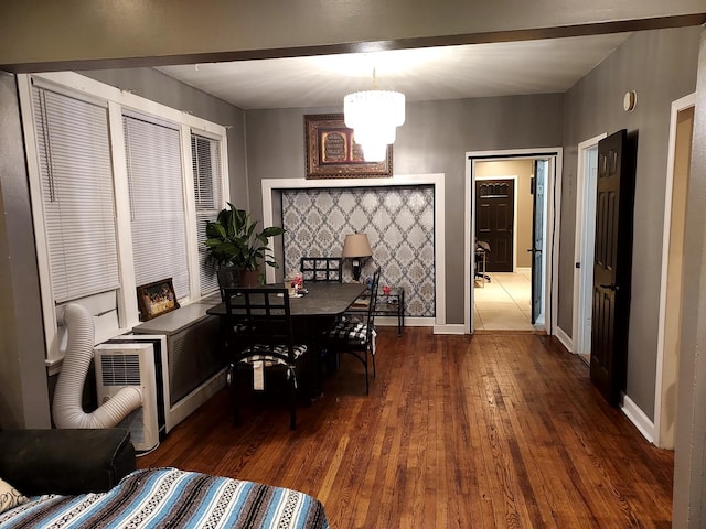 dining area with a chandelier and dark hardwood / wood-style floors