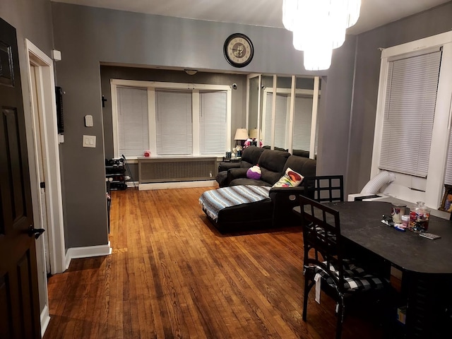 living room featuring hardwood / wood-style flooring and an inviting chandelier