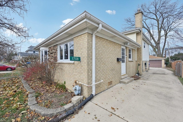 view of home's exterior featuring a garage and an outbuilding