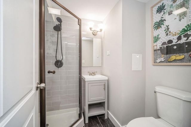 bathroom featuring backsplash, vanity, hardwood / wood-style flooring, toilet, and a shower with shower door