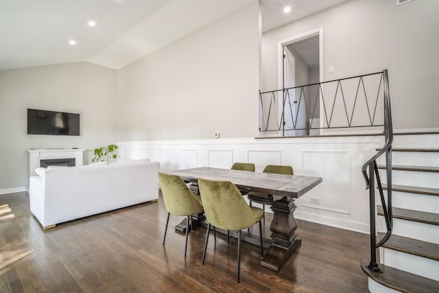 dining room featuring lofted ceiling and dark wood-type flooring