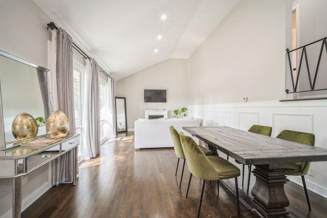 dining area with dark hardwood / wood-style floors and vaulted ceiling