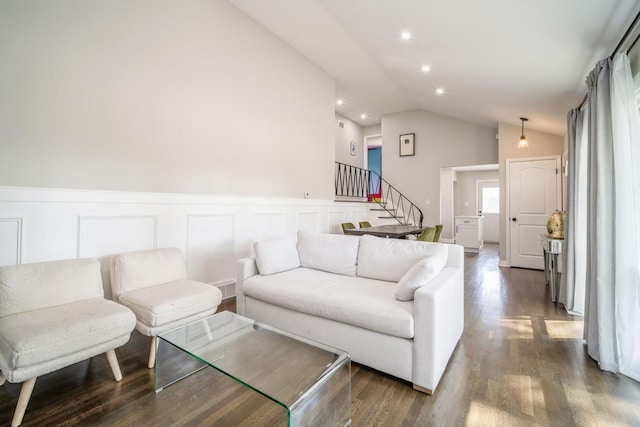 living room featuring dark hardwood / wood-style flooring and vaulted ceiling