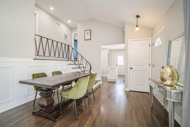 dining space featuring dark wood-type flooring and vaulted ceiling