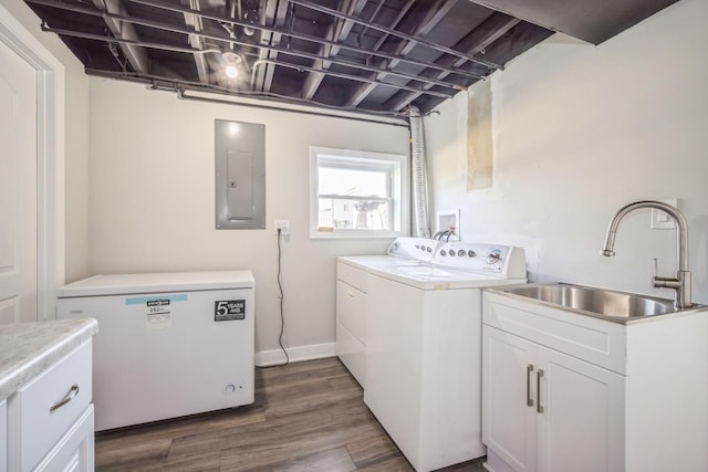 laundry room with washing machine and clothes dryer, sink, cabinets, dark hardwood / wood-style floors, and electric panel