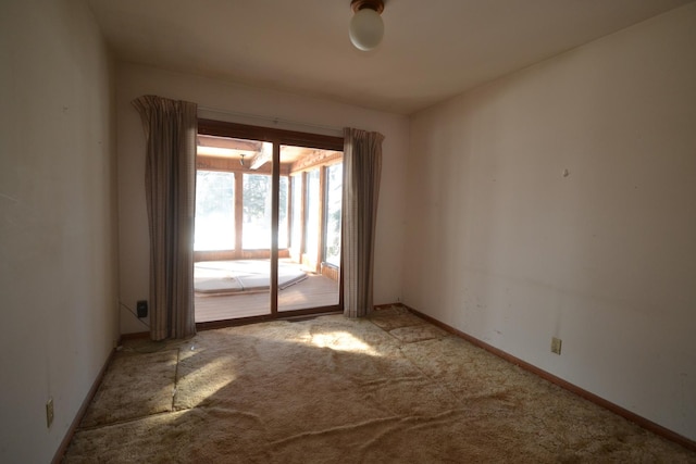 empty room with light colored carpet and baseboards