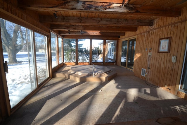 sunroom / solarium featuring beamed ceiling and wooden ceiling