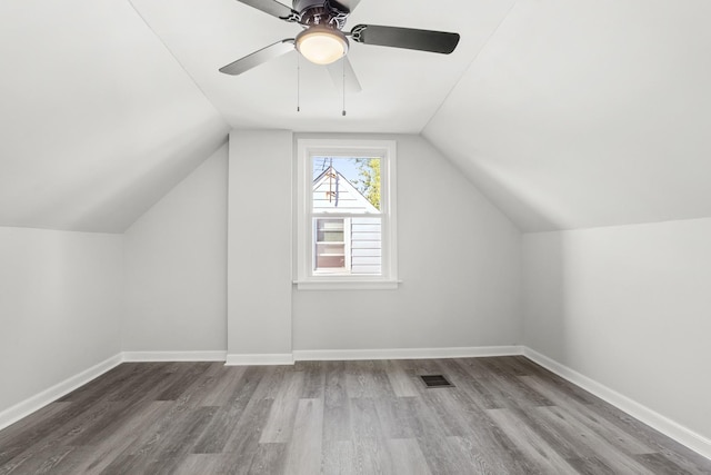 additional living space featuring ceiling fan, wood-type flooring, and vaulted ceiling