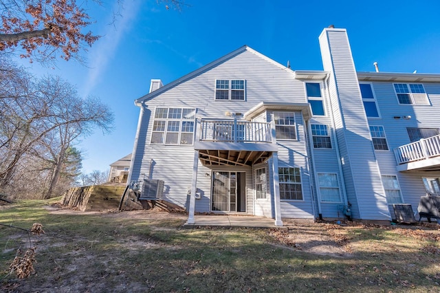 rear view of house with a patio area and a yard