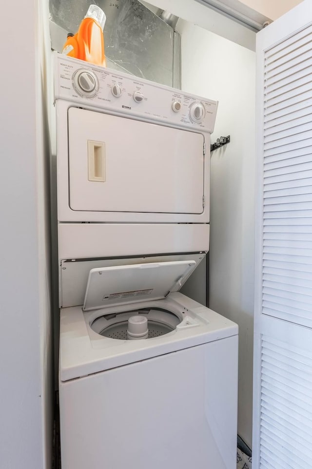 laundry area with stacked washer and dryer