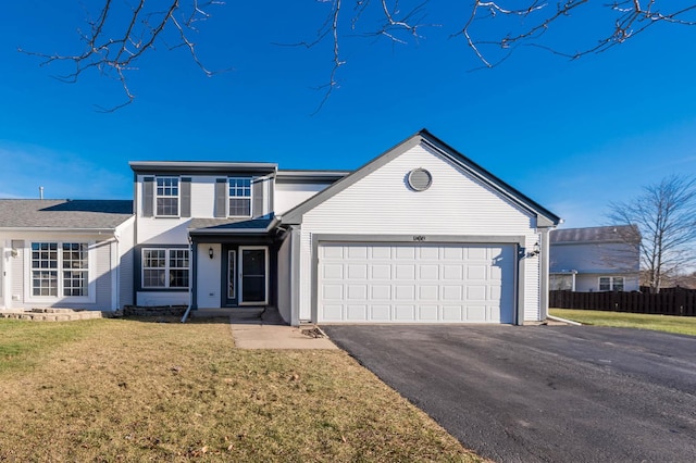 view of front property featuring a front lawn and a garage