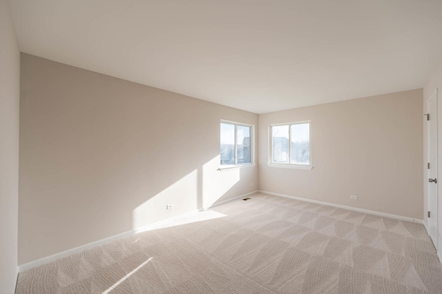 unfurnished room featuring light colored carpet