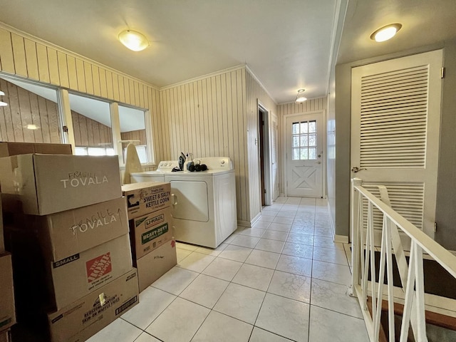 laundry area with separate washer and dryer, crown molding, and light tile patterned floors