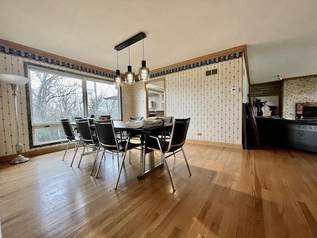 dining area featuring a chandelier and wood-type flooring