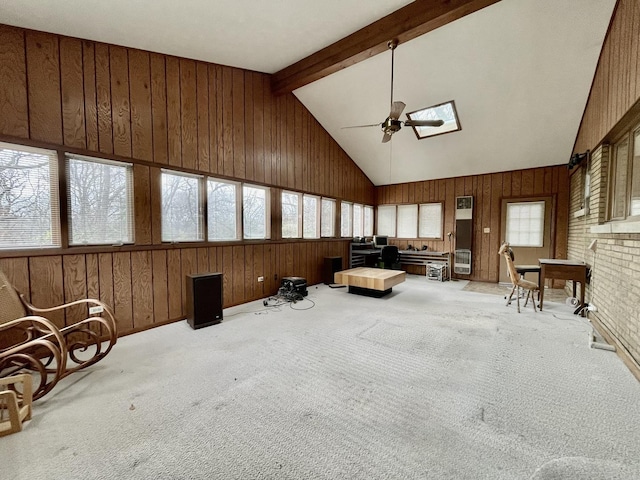 sunroom / solarium with ceiling fan and lofted ceiling with skylight