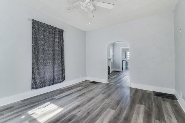 spare room with a textured ceiling, dark hardwood / wood-style floors, and ceiling fan