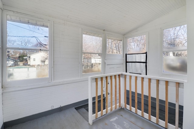 sunroom featuring a healthy amount of sunlight and vaulted ceiling