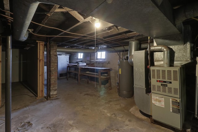 basement featuring heating unit and water heater