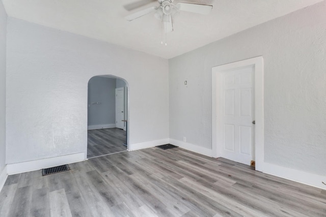 spare room featuring light wood-type flooring and ceiling fan